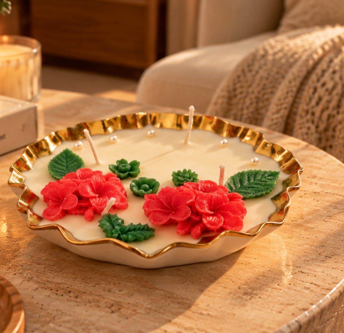 Brass Jar Candle: a wide candle with a wavy gold rim, four wicks and red wax flowers