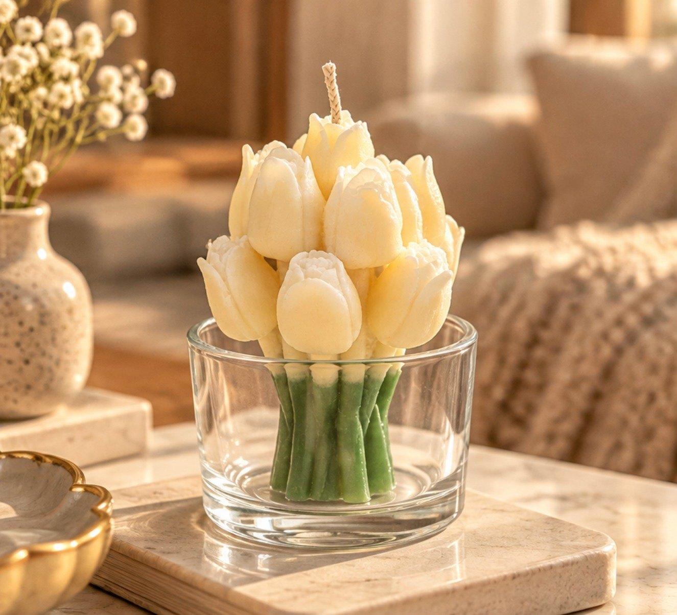 Tulip Jar Candle: cream wax tulips on green stems in a clear glass jar, on a marble tray